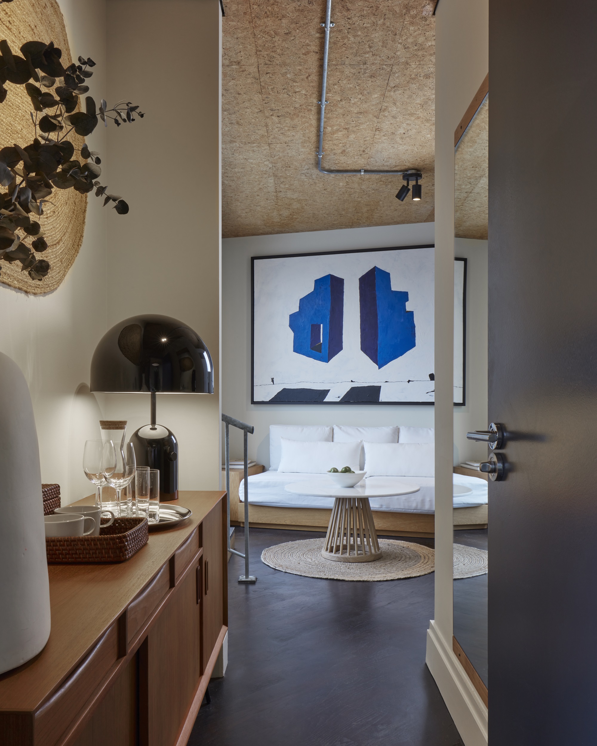 A spacious, contemporary suite at One Hundred Shoreditch with a minimalist design, offering an inviting space for relaxation.