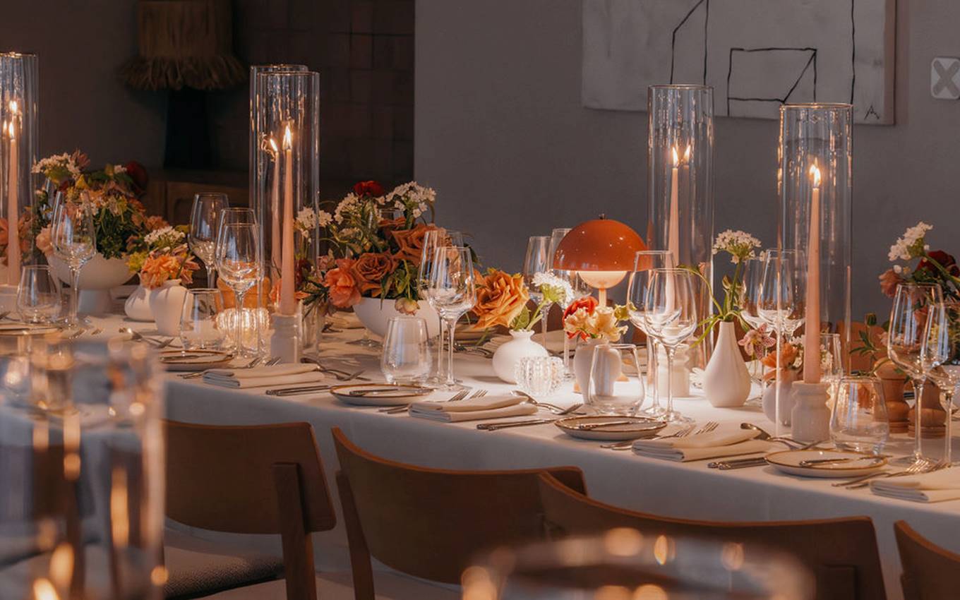 A beautifully arranged table featuring candles and flowers, creating an elegant and inviting atmosphere.