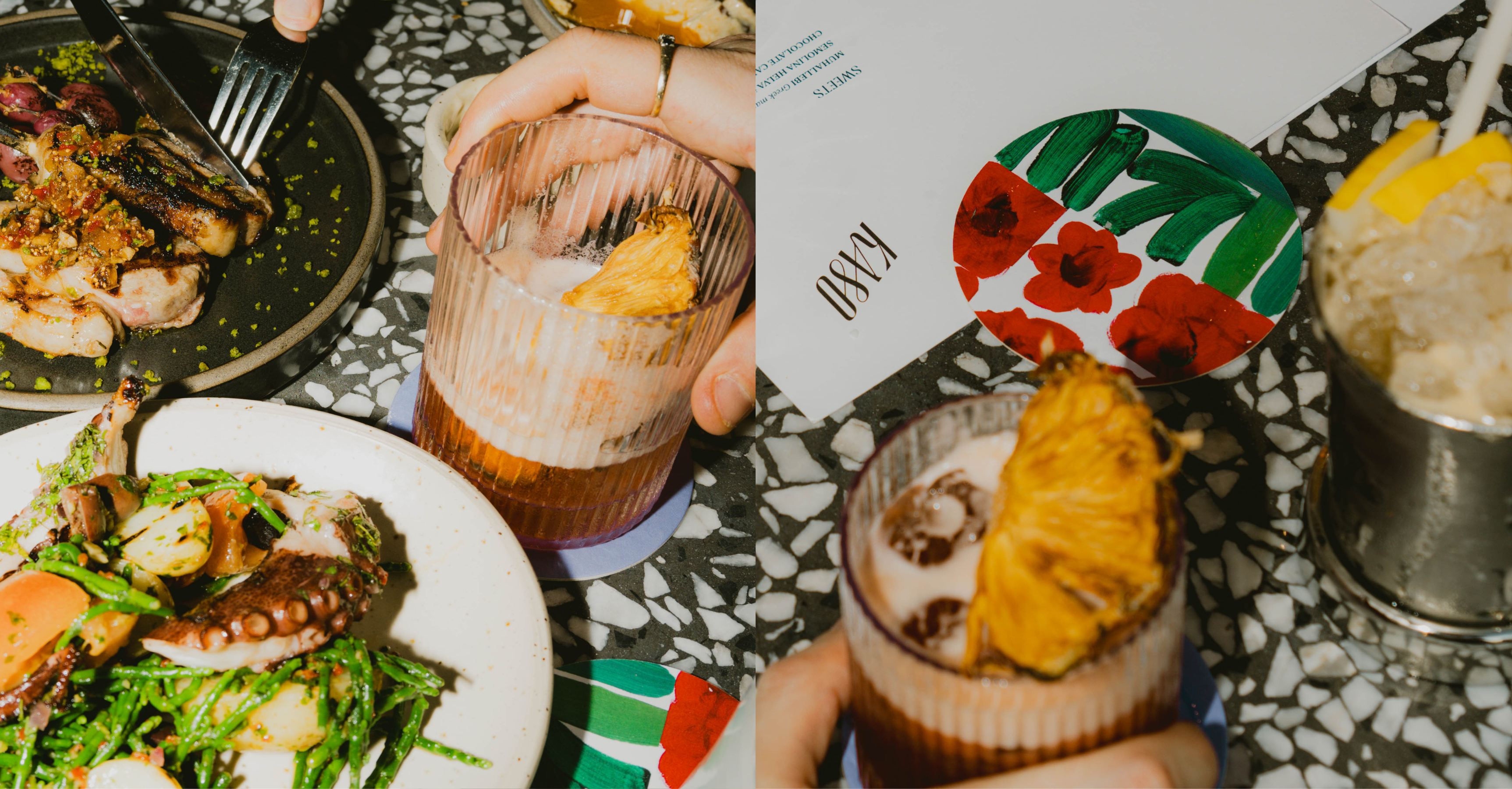 A lively dinner scene with close-up of a cocktail garnished with dried pineapple with colourful coasters and a steak dish.