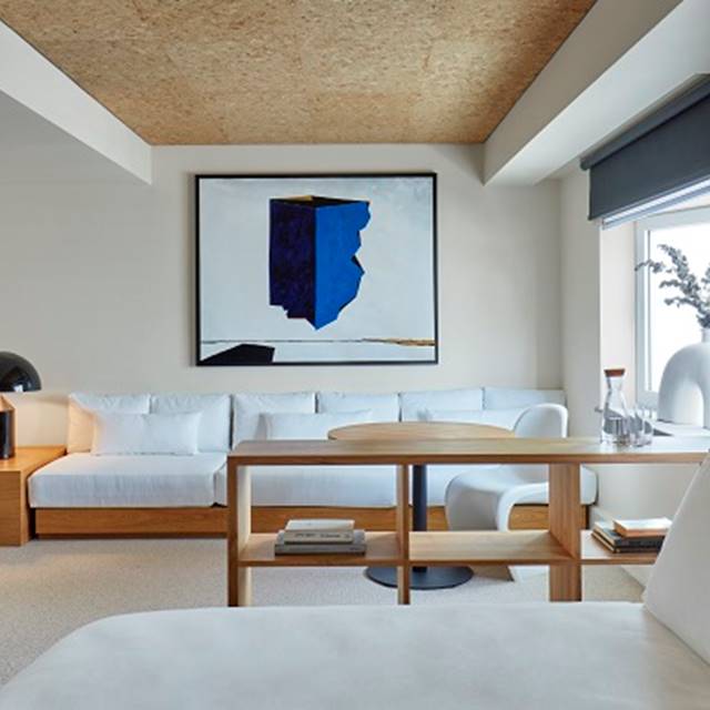 A white couch and a table are arranged in a cosy room, creating a welcoming and stylish atmosphere.