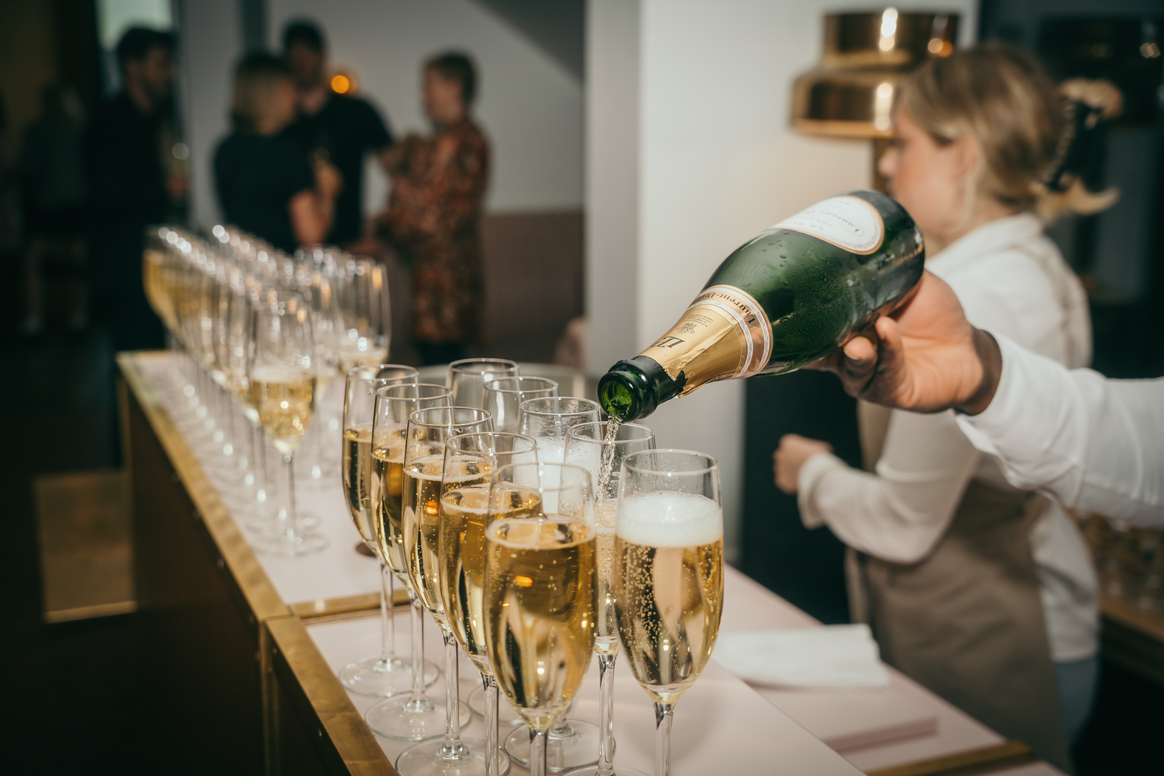 Champagne being elegantly poured into glasses, capturing the festive atmosphere of a lively party celebration.